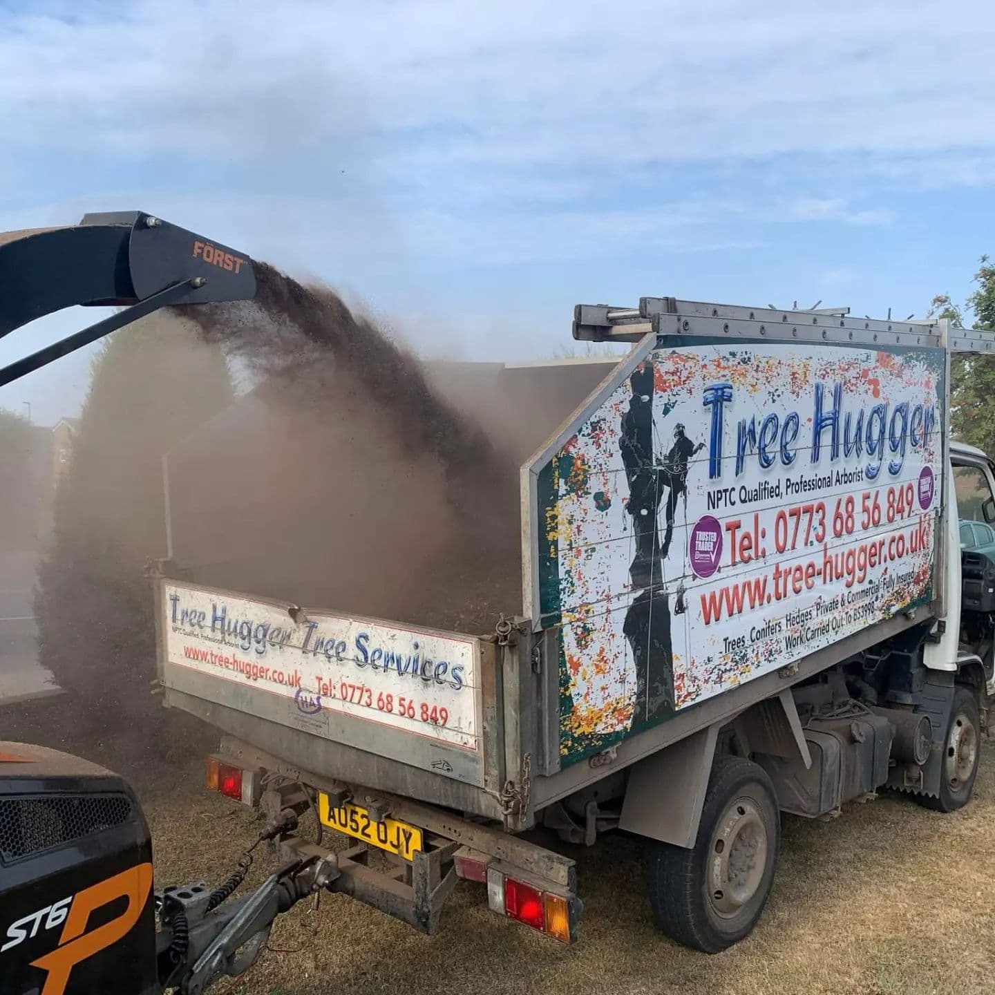 Tree Hugger tip truck offloading woodchip